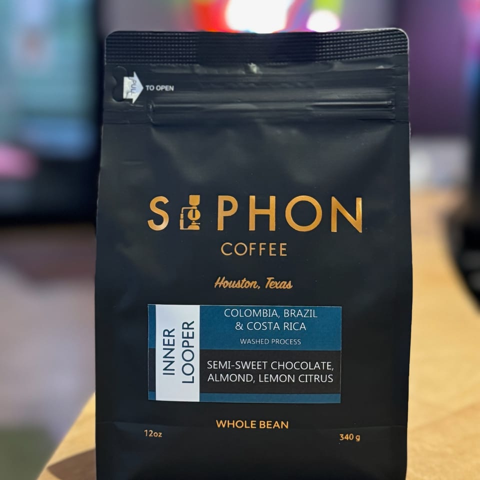 A black bag of Siphon Coffee "Inner Looper" whole beans with flavor notes of chocolate, almond, and citrus.